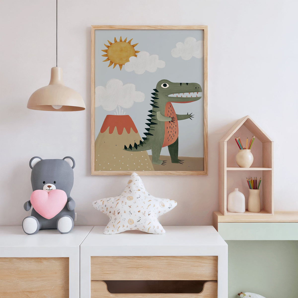 Dinosaur and volcano nursery print in an oak frame above a white dresser with a star pillow and house shelf