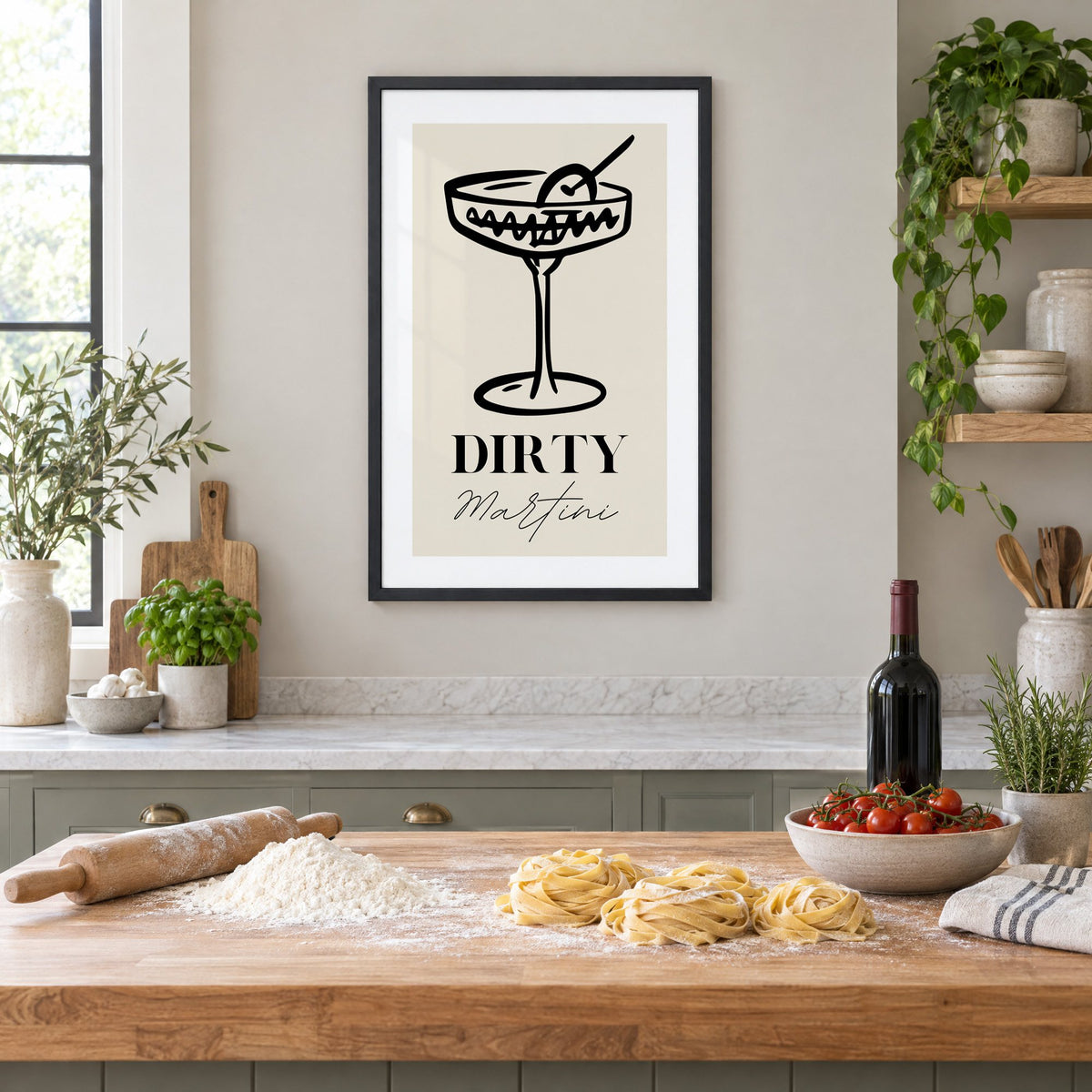 DIRTY Martini black line coupe olive print in a black frame above a butcher-block island with fresh pasta, flour and cherry tomatoes