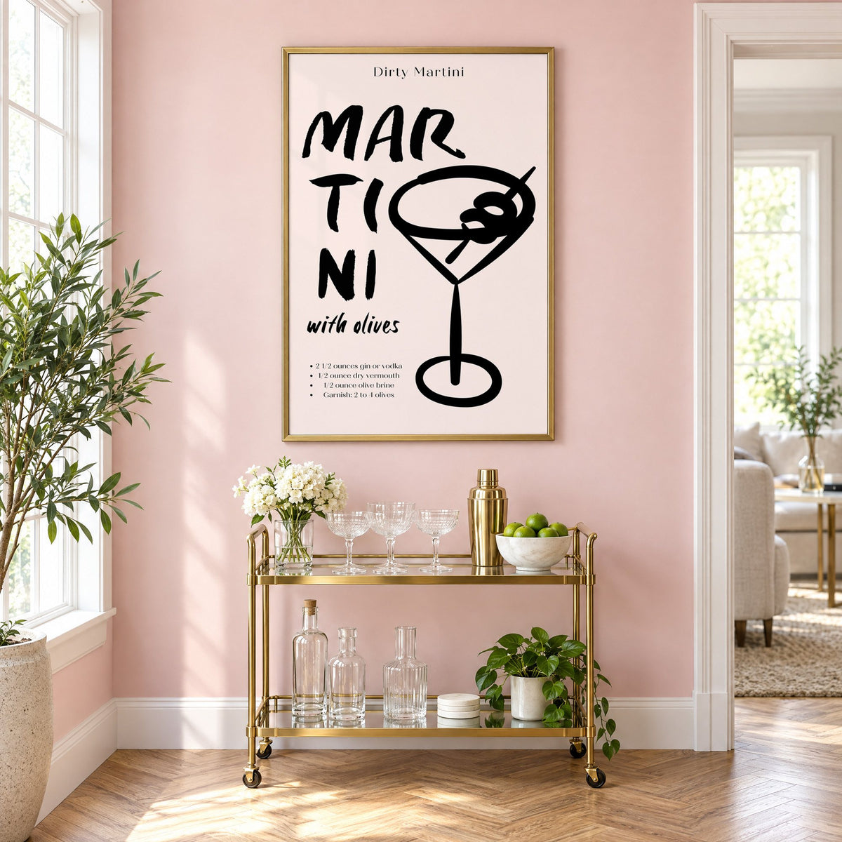 Dirty Martini with olives recipe print in a brass frame above a gold bar cart on a blush pink wall