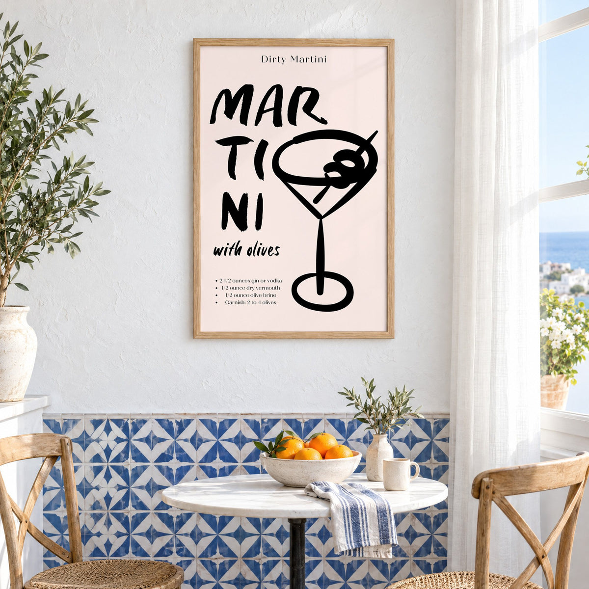 Dirty Martini with olives recipe print in an oak frame above a bistro table and blue patterned tiles