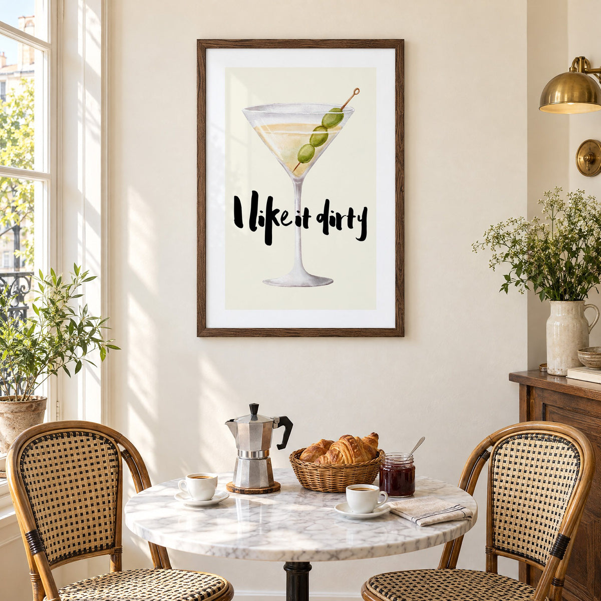 I like it dirty watercolor martini print in a walnut frame above a marble bistro table with croissants and rattan chairs