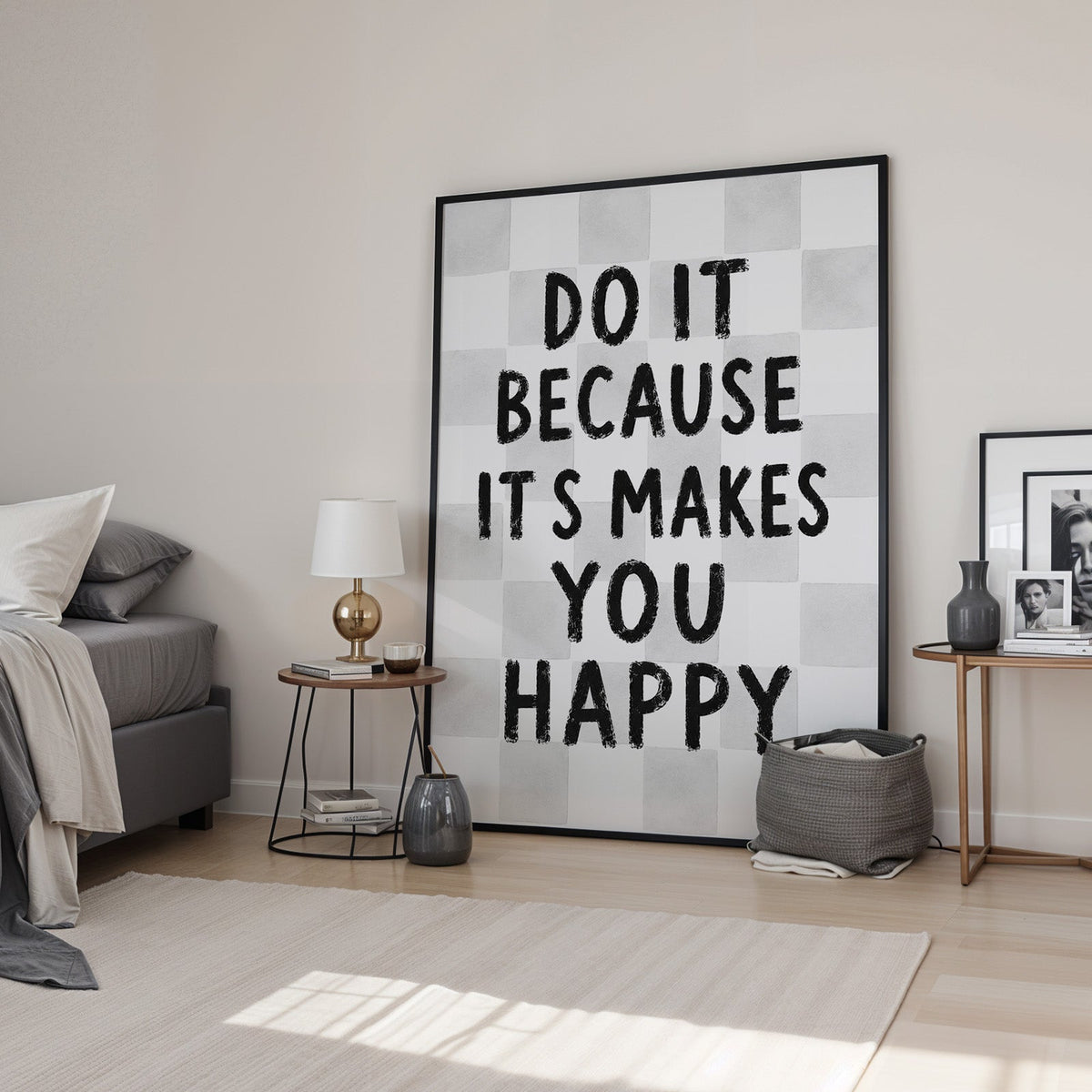 Do it because it makes you happy checkered print in a black frame leaning in a bedroom beside a gold lamp