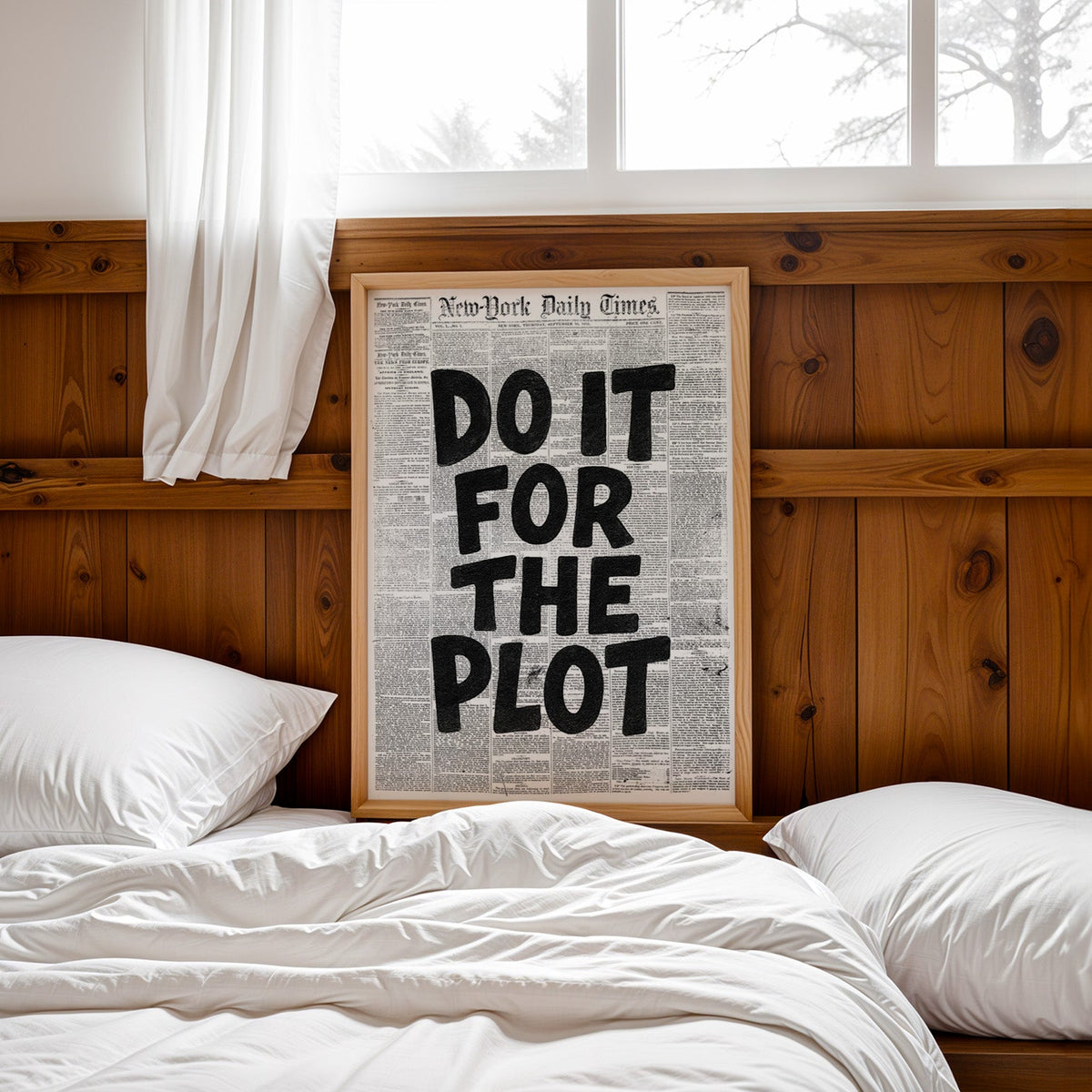 Do It for the Plot black lettering on old newspaper print in a pine frame leaning on a wood headboard over white bedding