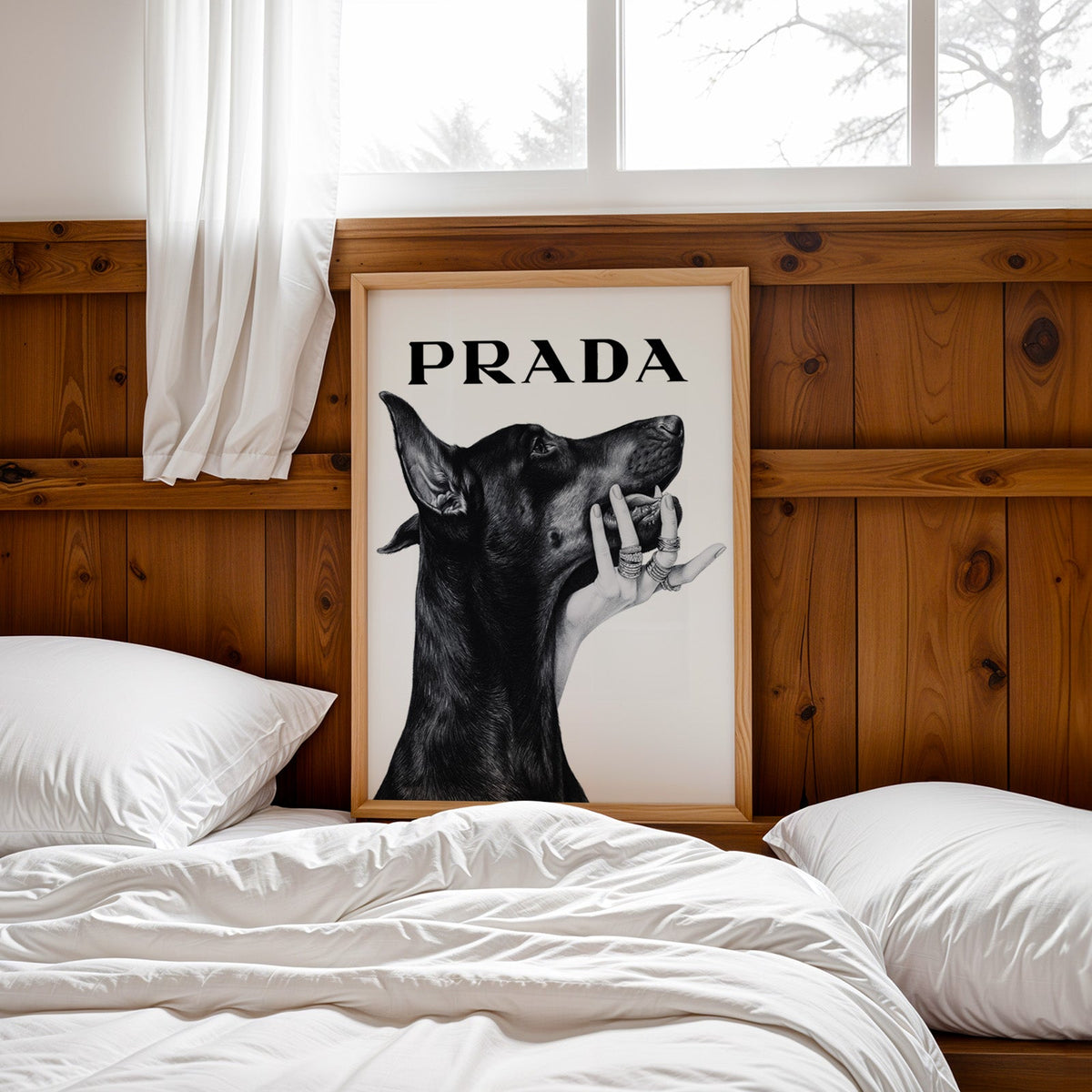 Drawn Doberman with ringed hand under chin print in a pine frame leaning on a wood headboard over white bedding