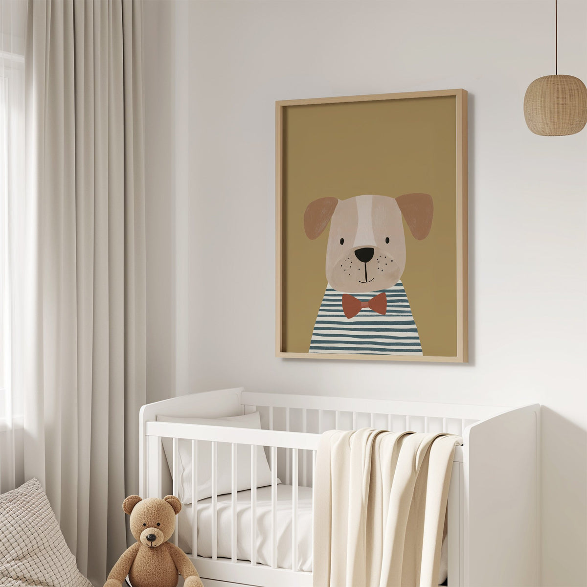 Dog in bow tie portrait nursery print in an oak frame above a white crib with a teddy bear