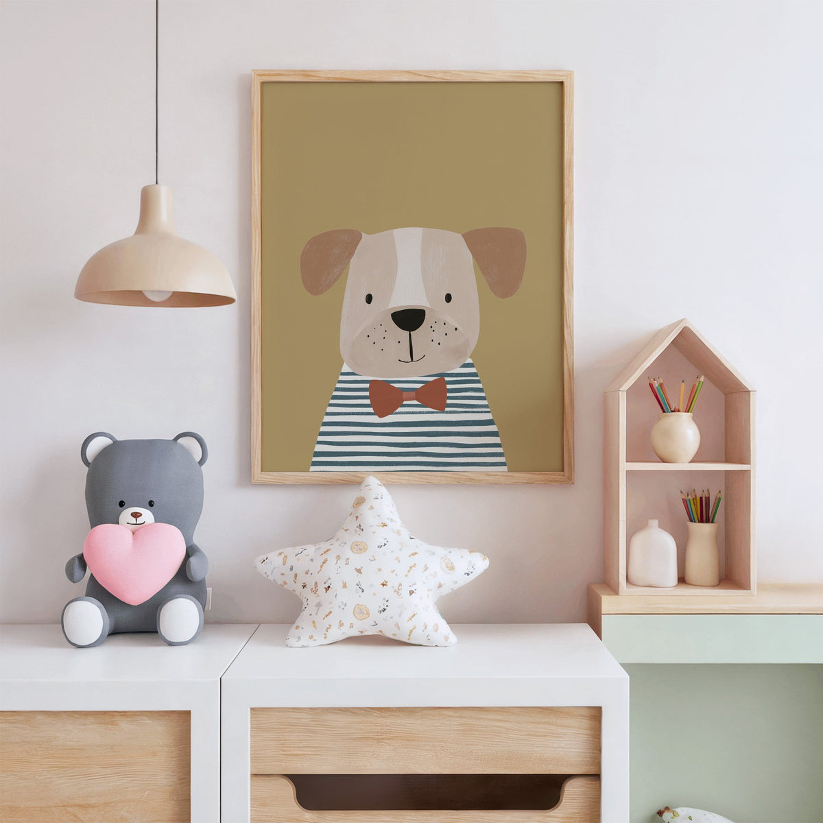 Dog in bow tie portrait nursery print in an oak frame above a white dresser with a star pillow and house shelf