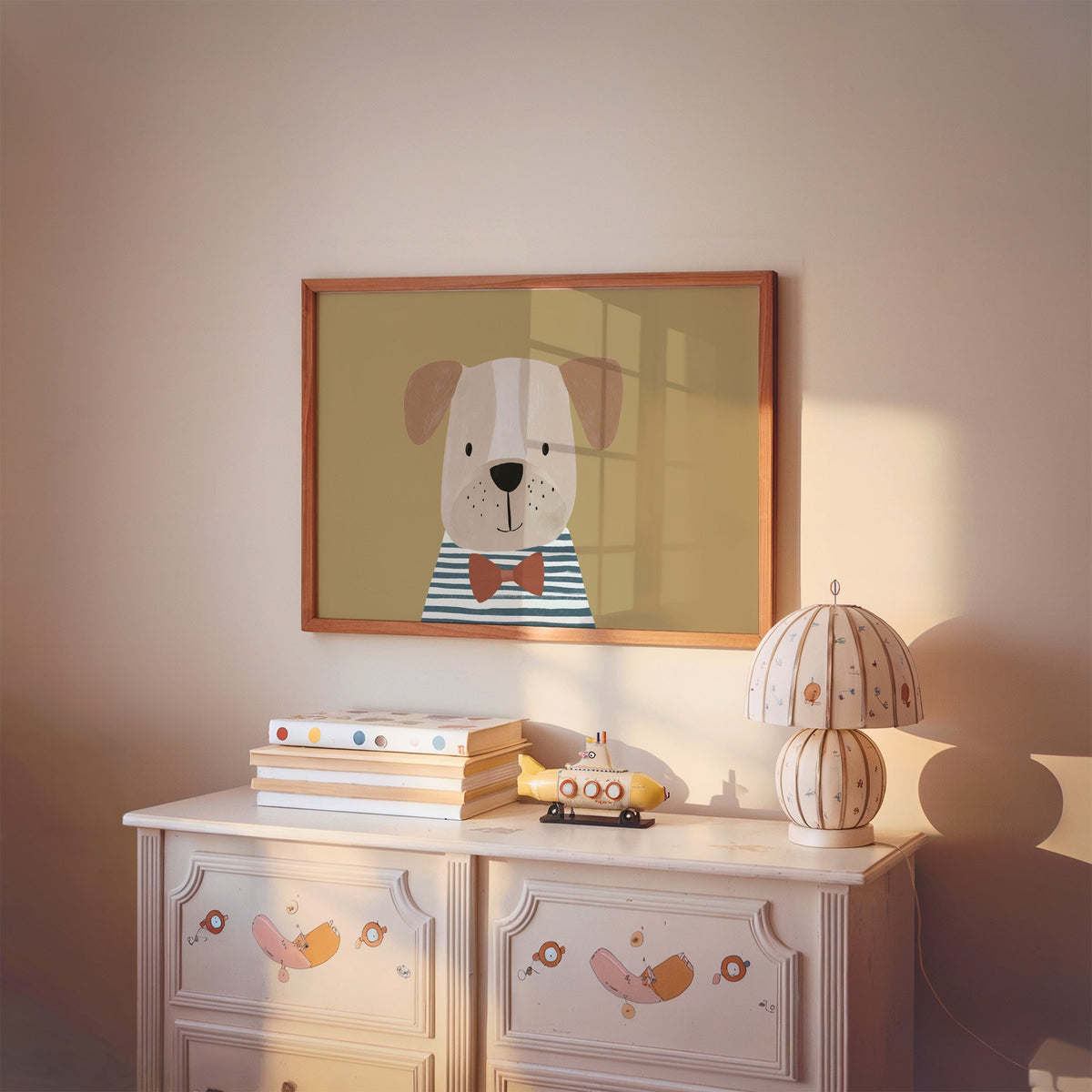 Landscape dog in bow tie portrait nursery print in a cherry wood frame above a painted dresser and lamp