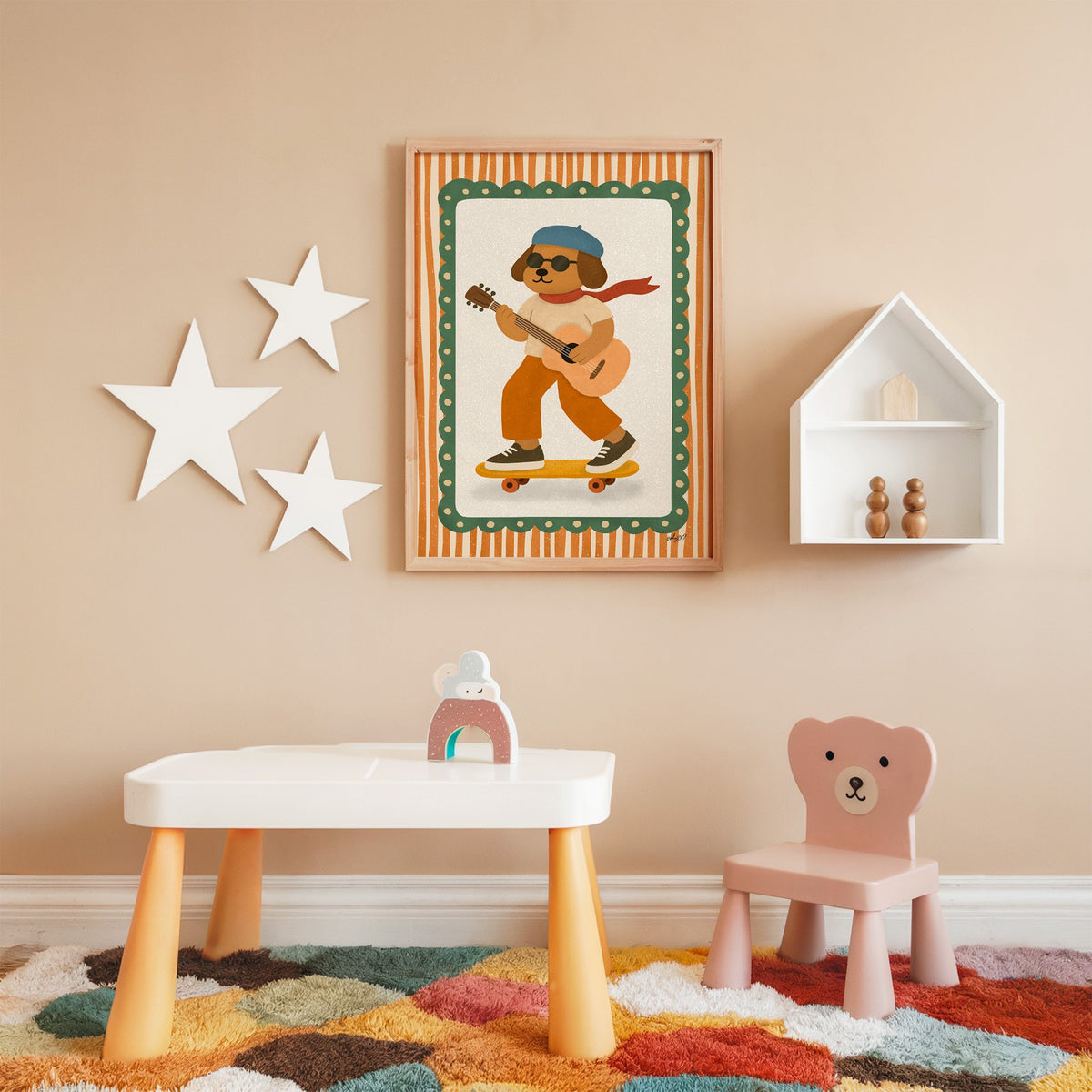 Brown dog with guitar on skateboard nursery print in an oak frame on a peach wall above a kids table with wall stars