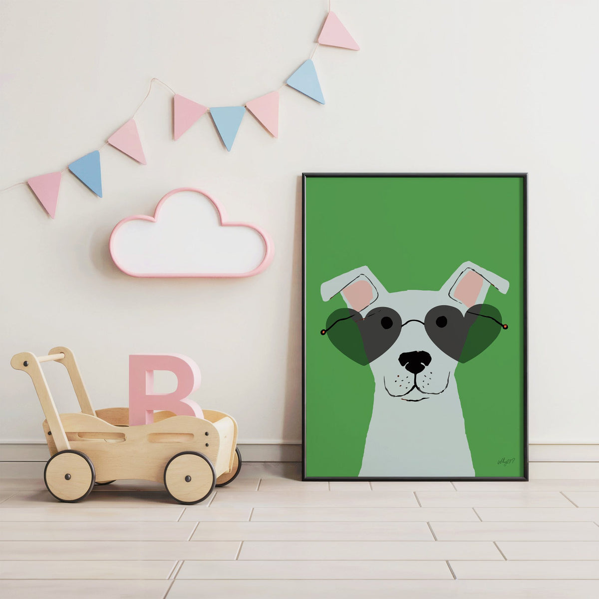 White dog in heart sunglasses nursery print in a black frame under pastel bunting by a wooden baby walker