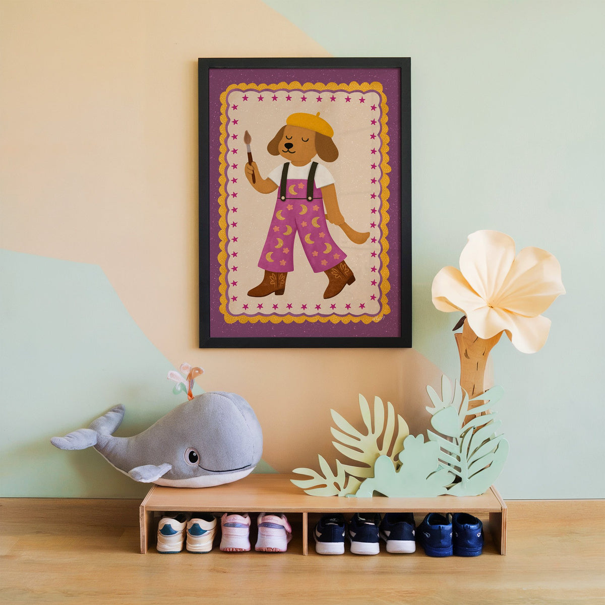 Painter dog in yellow beret nursery print in a black frame on a mint and peach wall above a whale plush