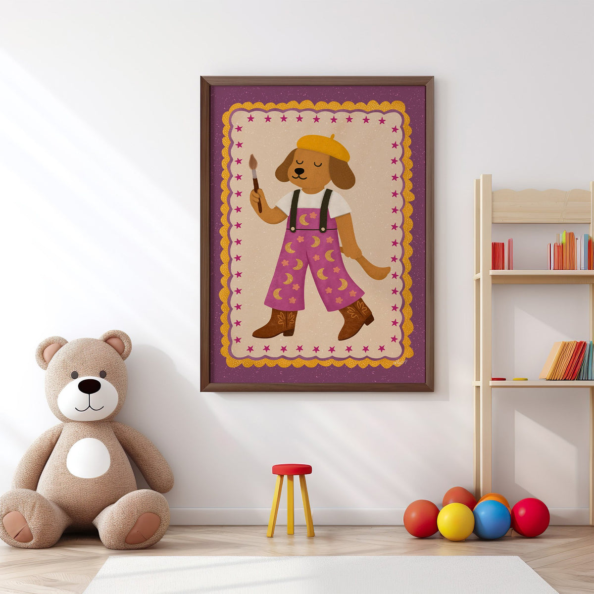 Painter dog in yellow beret nursery print in a walnut frame above a big teddy bear by a bookshelf