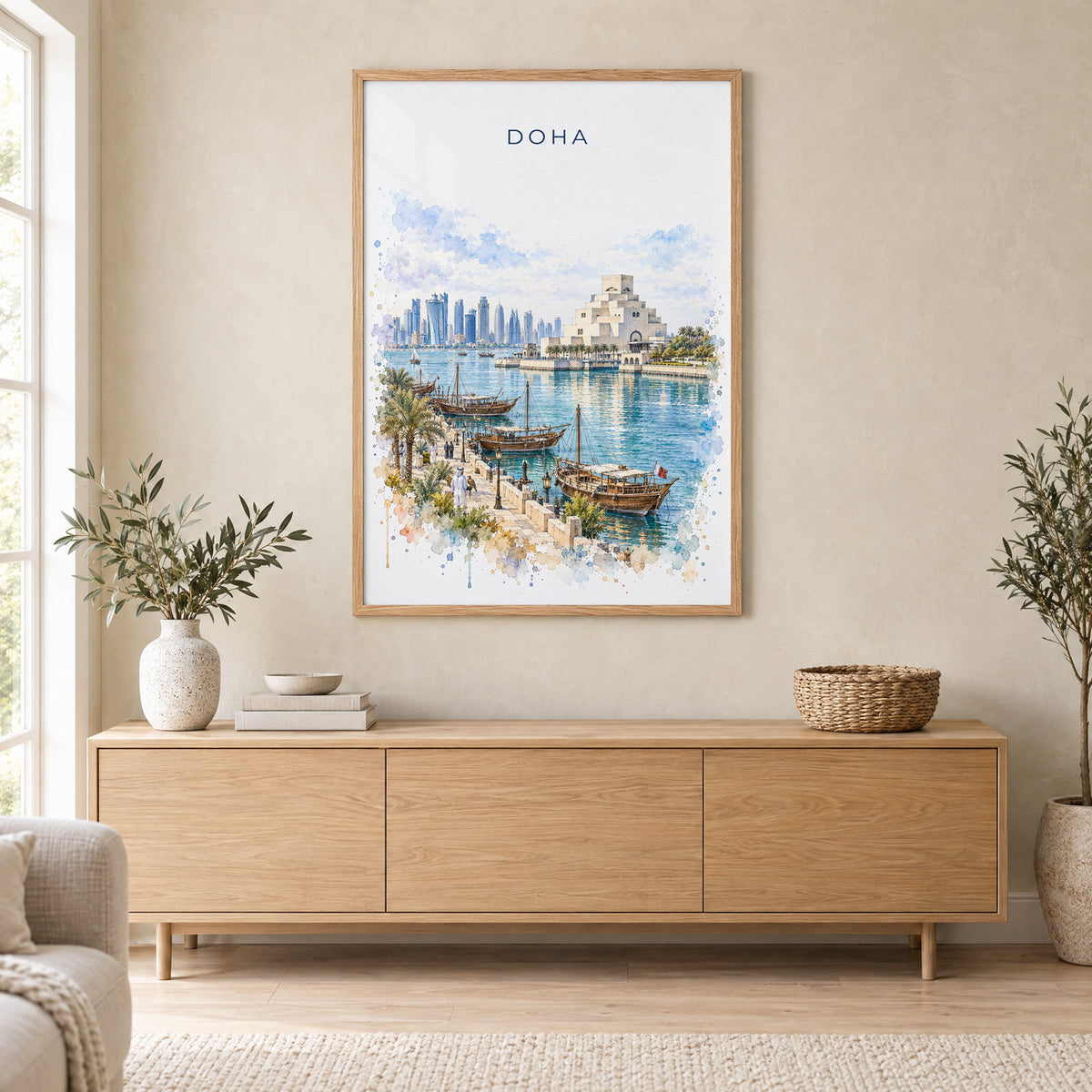Doha watercolor print in an oak frame above a light wood sideboard in a Scandinavian living room