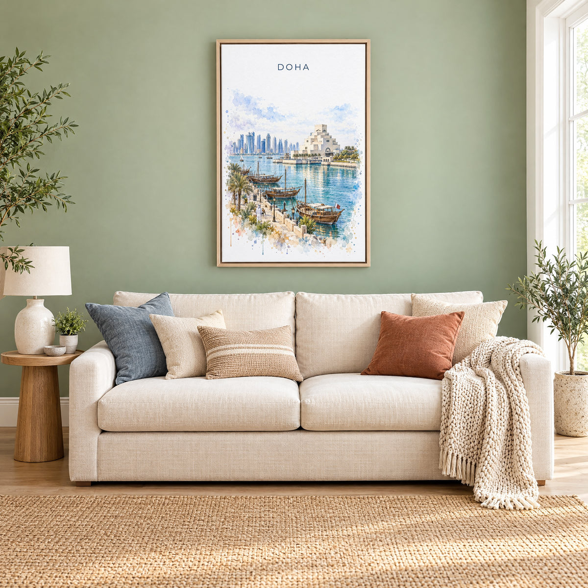 Doha watercolor print as a natural floater canvas above a cream linen sofa on a sage green wall