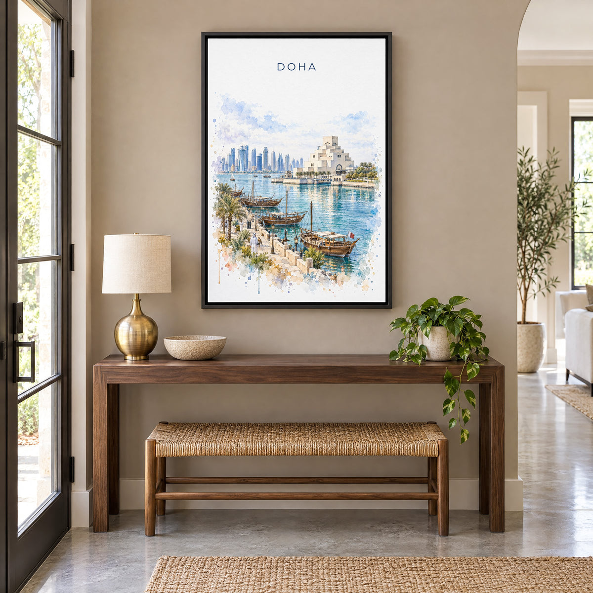 Doha watercolor print as a black floater canvas above a walnut console and woven bench in an entryway
