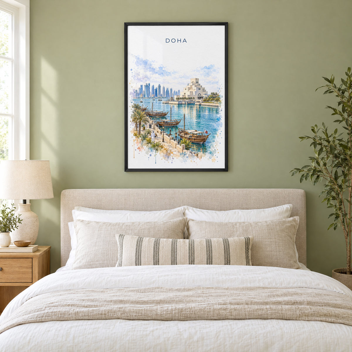 Doha watercolor print in a black frame above an upholstered headboard in a sage green bedroom