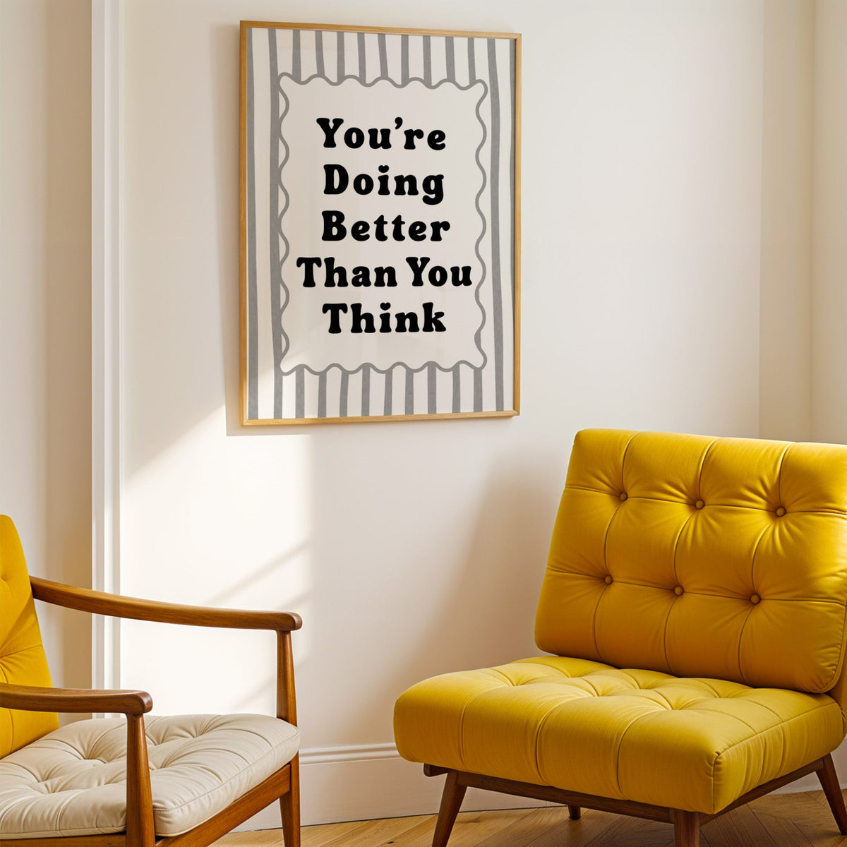 You're doing better than you think striped quote print shown in a gold frame above a mustard yellow tufted armchair