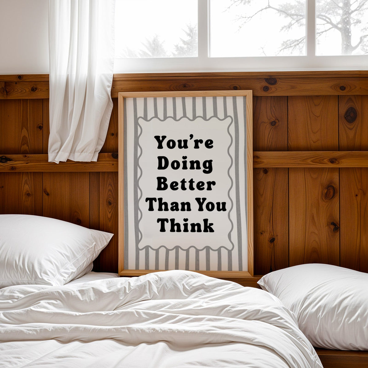 You're doing better than you think striped quote print in a pine frame leaning on a wood headboard over white bedding