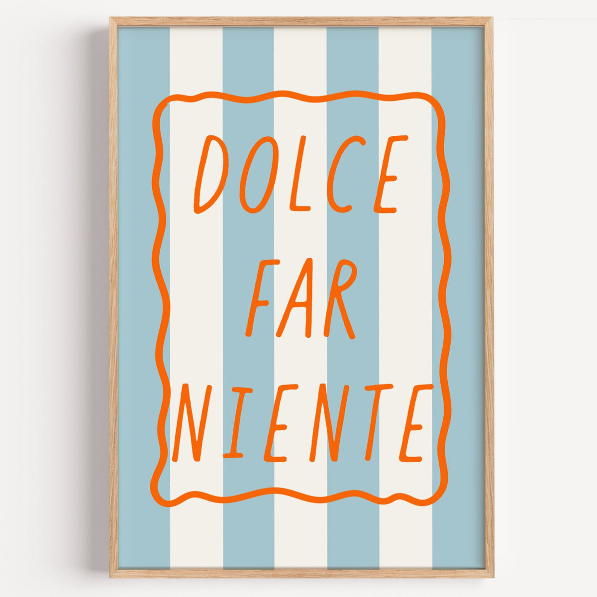 Dolce far niente print in a light oak frame on a plain white wall