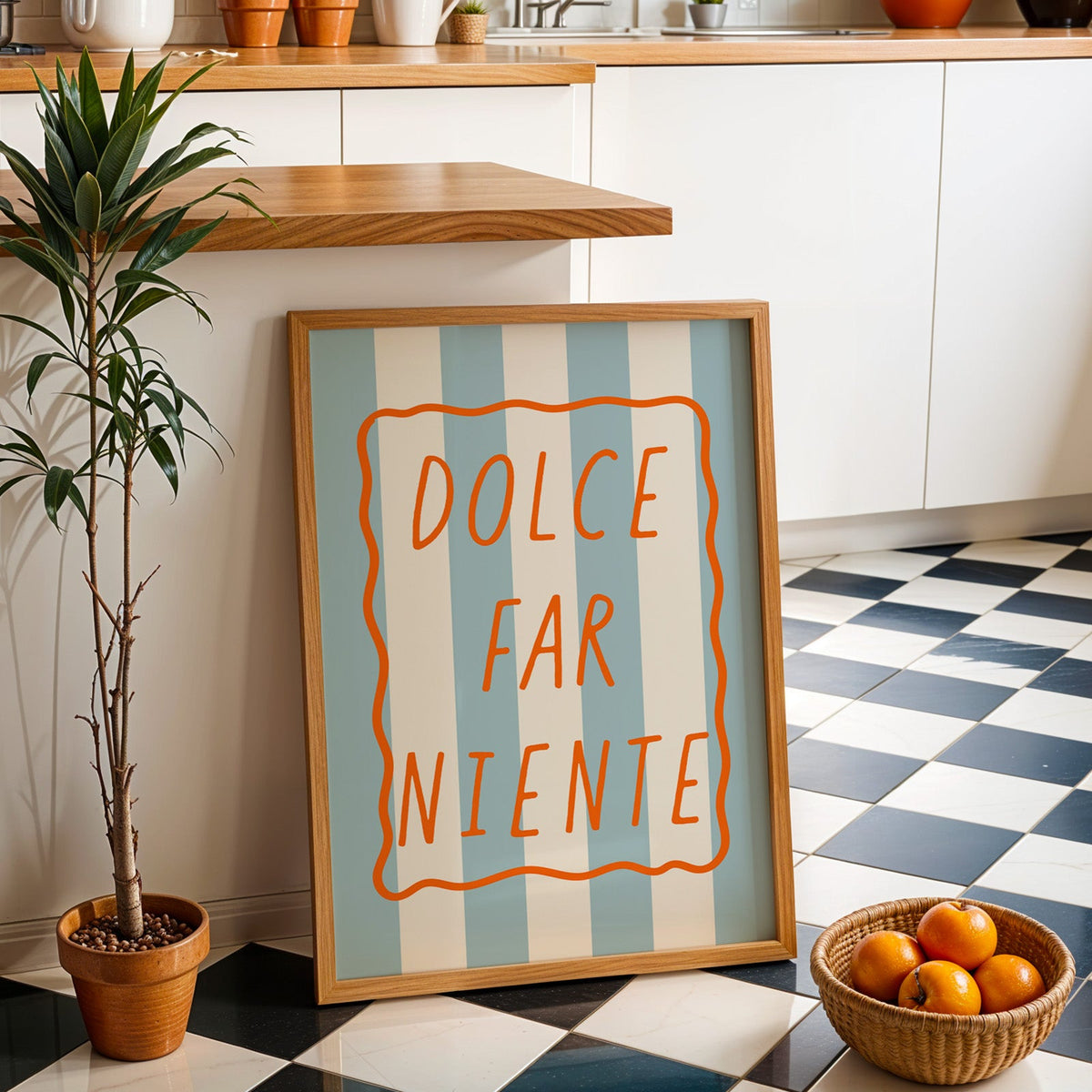 Dolce far niente print in an oak frame by a kitchen island and checkered floor