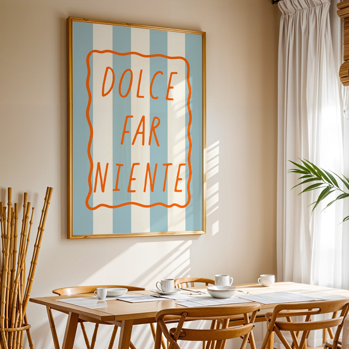 Dolce far niente print in a gold frame above a sunlit breakfast table