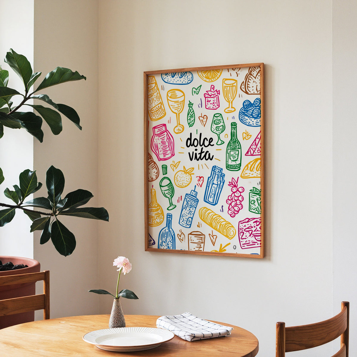 Dolce Vita doodle print in a walnut frame above a round table beside a fiddle-leaf fig
