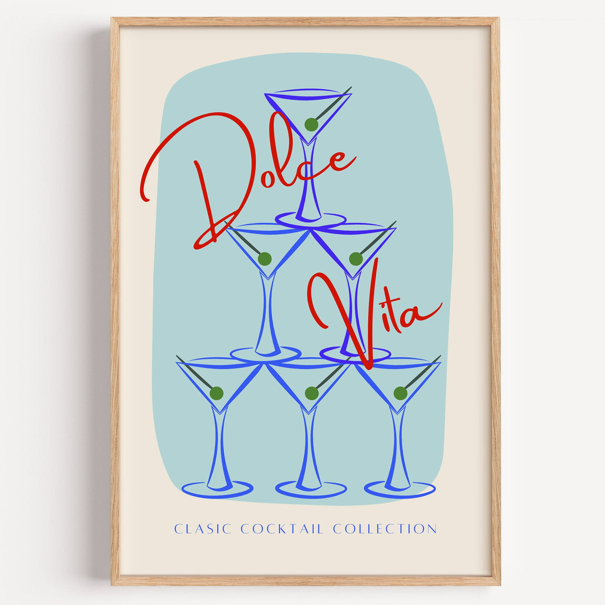 Dolce Vita martini tower print in a light oak frame on a plain white wall