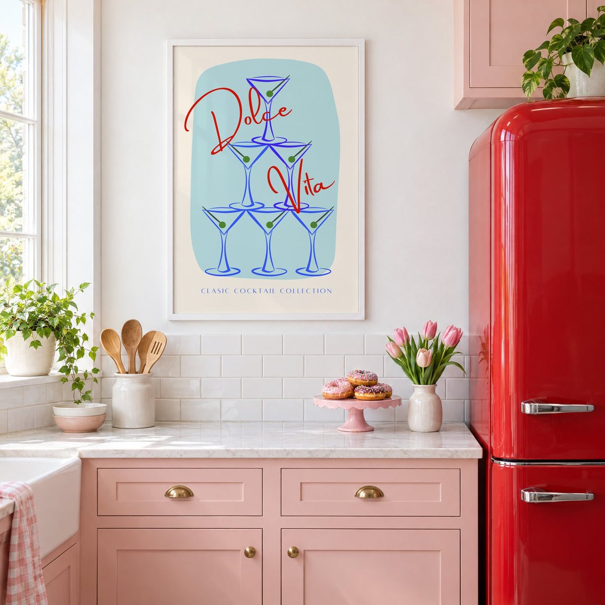 Dolce Vita martini tower print in a white frame in a pink kitchen beside a red retro fridge
