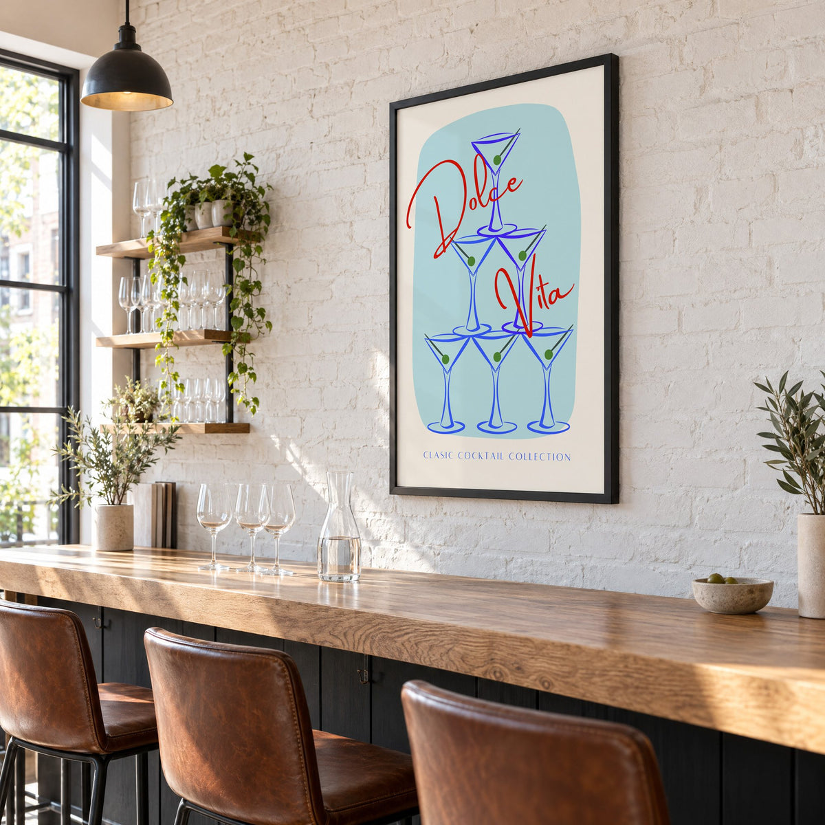Dolce Vita martini tower print in a black frame on a white brick wall above a wine bar counter