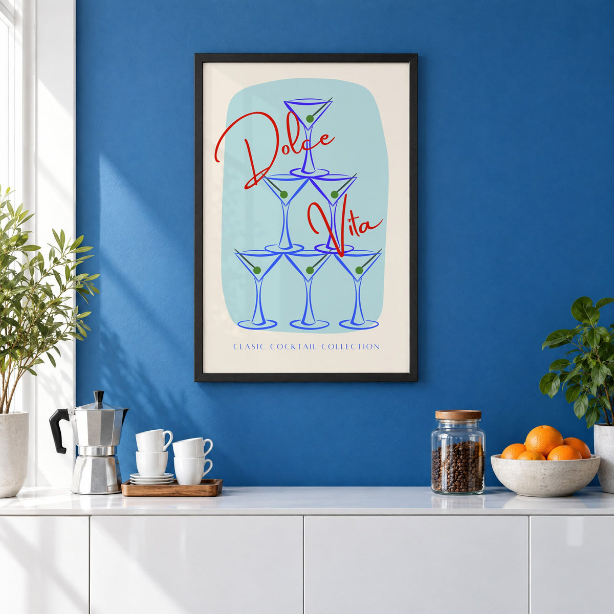 Dolce Vita martini tower print in a black frame on a cobalt blue wall above a coffee station