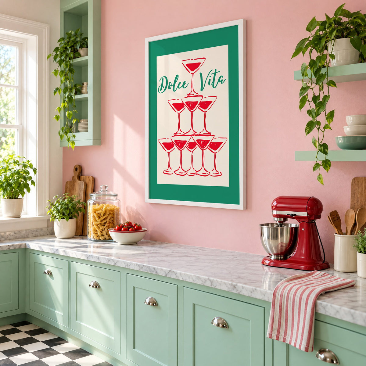 Dolce Vita red martini tower print in a white frame on a pink wall above mint green cabinets in a retro kitchen, seen at an angle