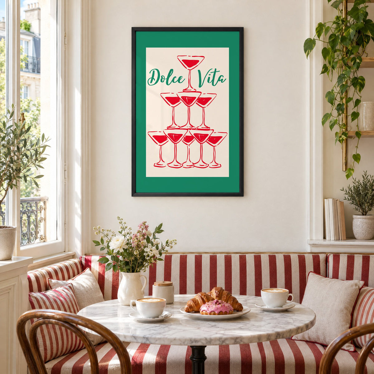 Dolce Vita red martini tower print in a black frame above a striped cafe breakfast nook with cappuccino and pastries