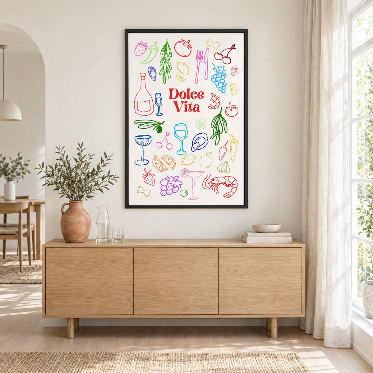 Dolce Vita rainbow doodle print in a black frame above an oak sideboard with a terracotta vase of olive branches