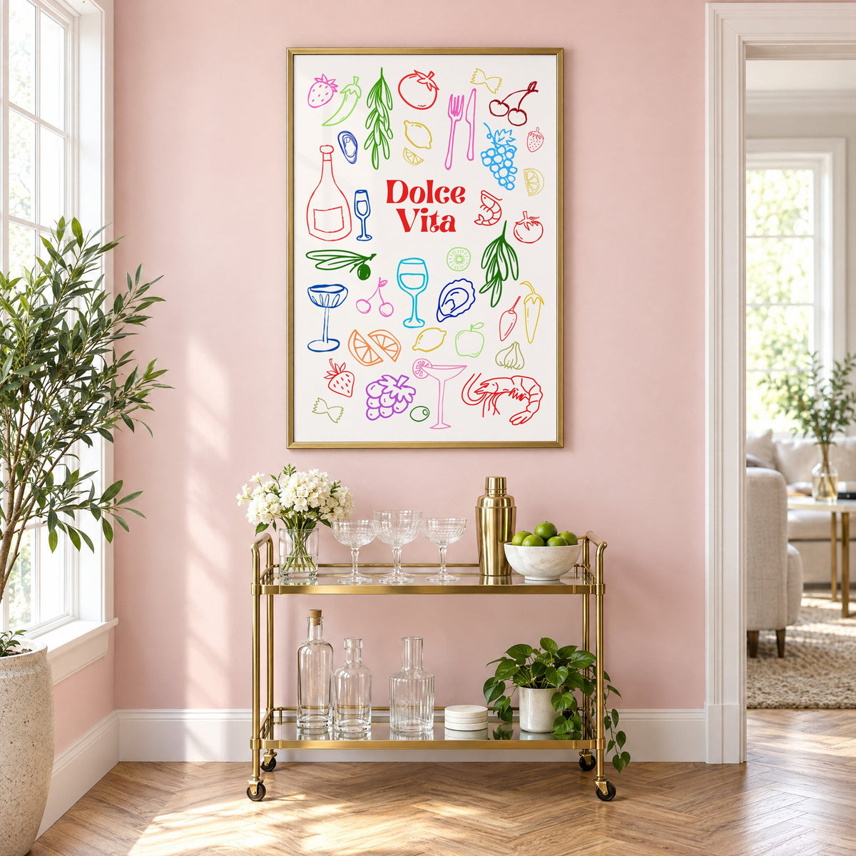 Dolce Vita rainbow doodle print in a brass frame above a gold bar cart on a blush pink wall