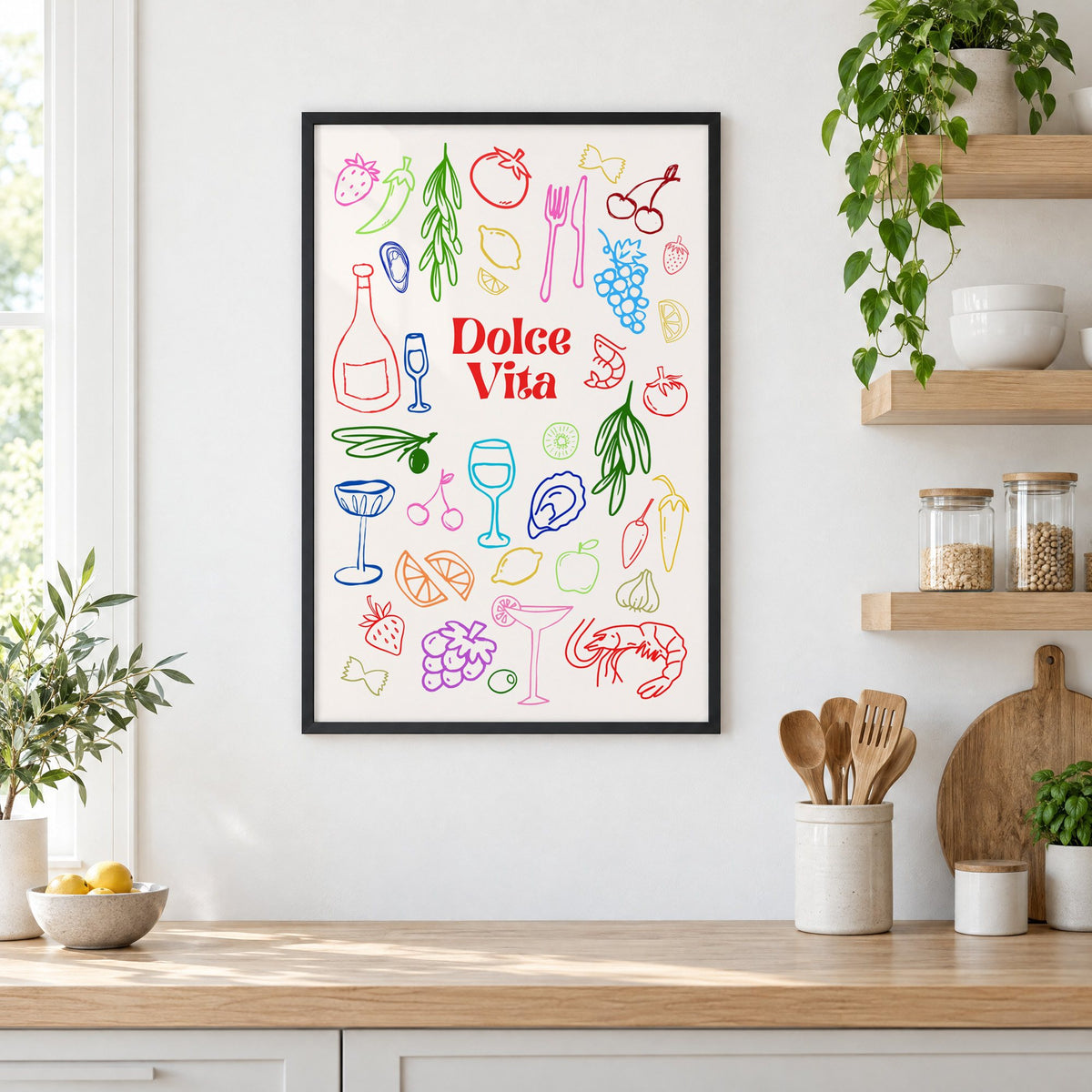Dolce Vita rainbow doodle print in a black frame in a white kitchen beside open wood shelves and glass jars