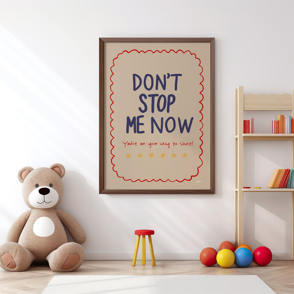 Dont stop me now star lettering nursery print in a walnut frame above a big teddy bear by a bookshelf