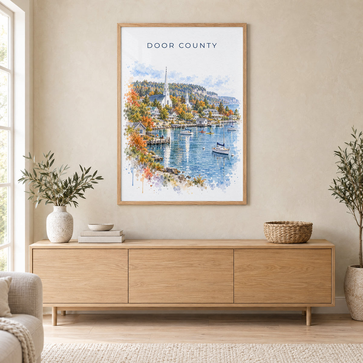 Door County watercolor print in an oak frame above a light wood sideboard in a Scandinavian living room