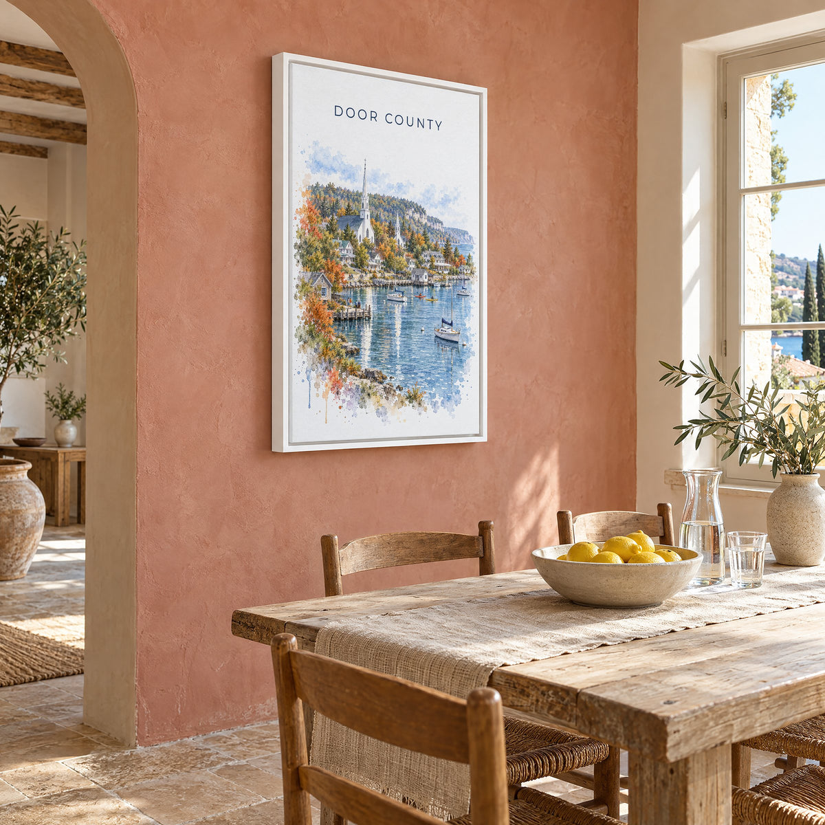 Door County watercolor print as a white floater canvas on a terracotta wall above a rustic dining table