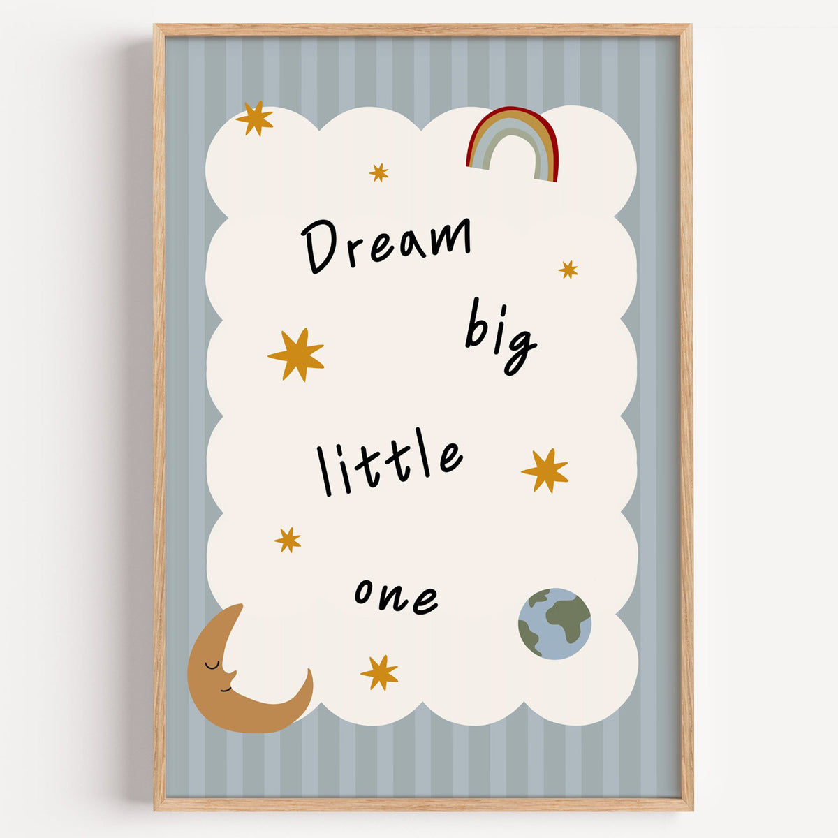 Dream big little one rainbow nursery print in a light oak frame on a plain white wall