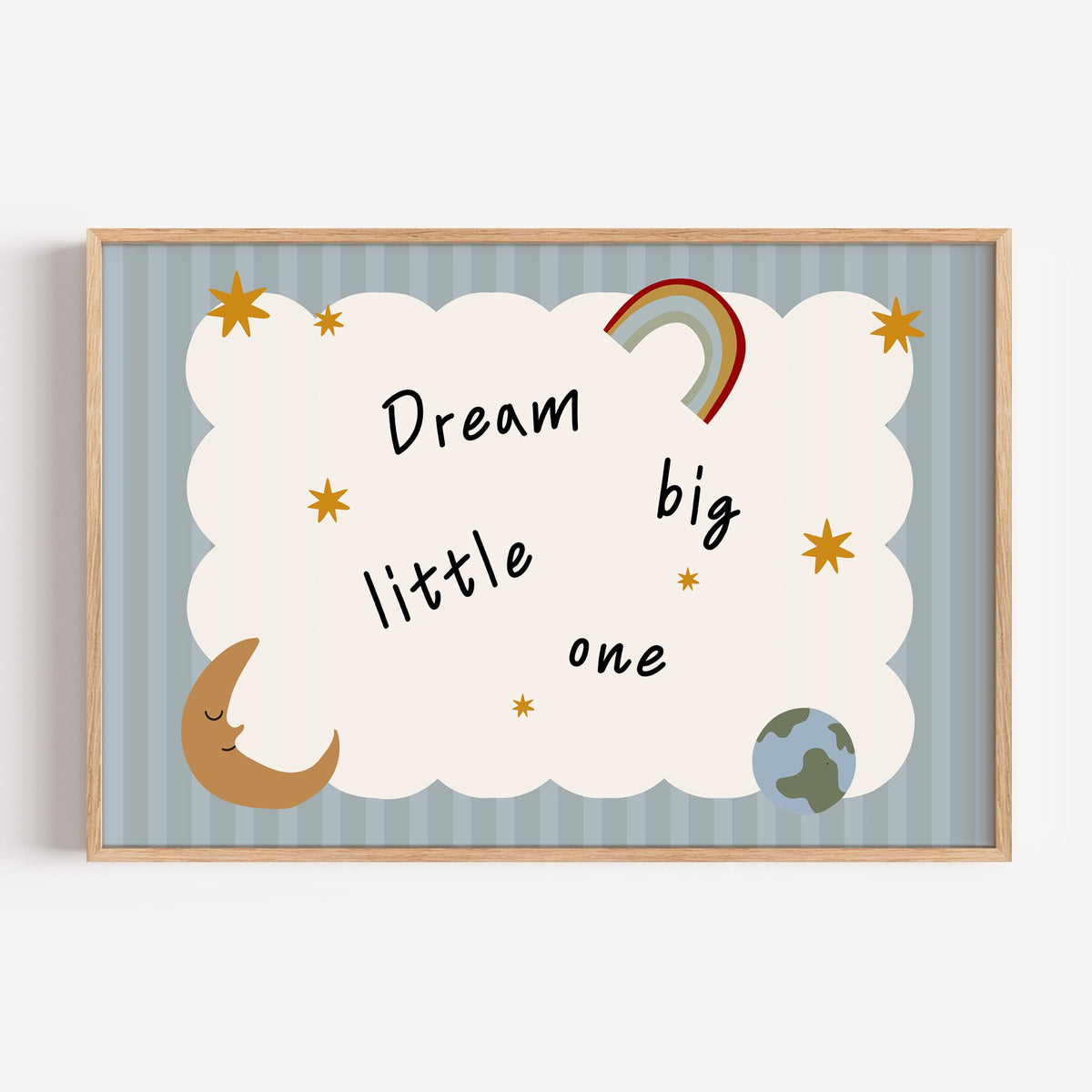 Landscape dream big little one rainbow nursery print in a light oak frame on a plain white wall