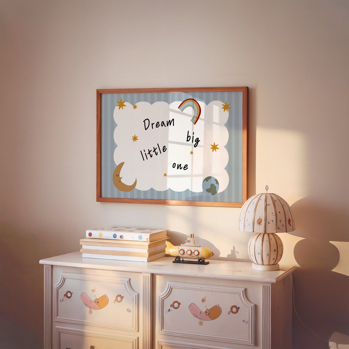 Landscape dream big little one rainbow nursery print in a cherry wood frame above a painted dresser and lamp