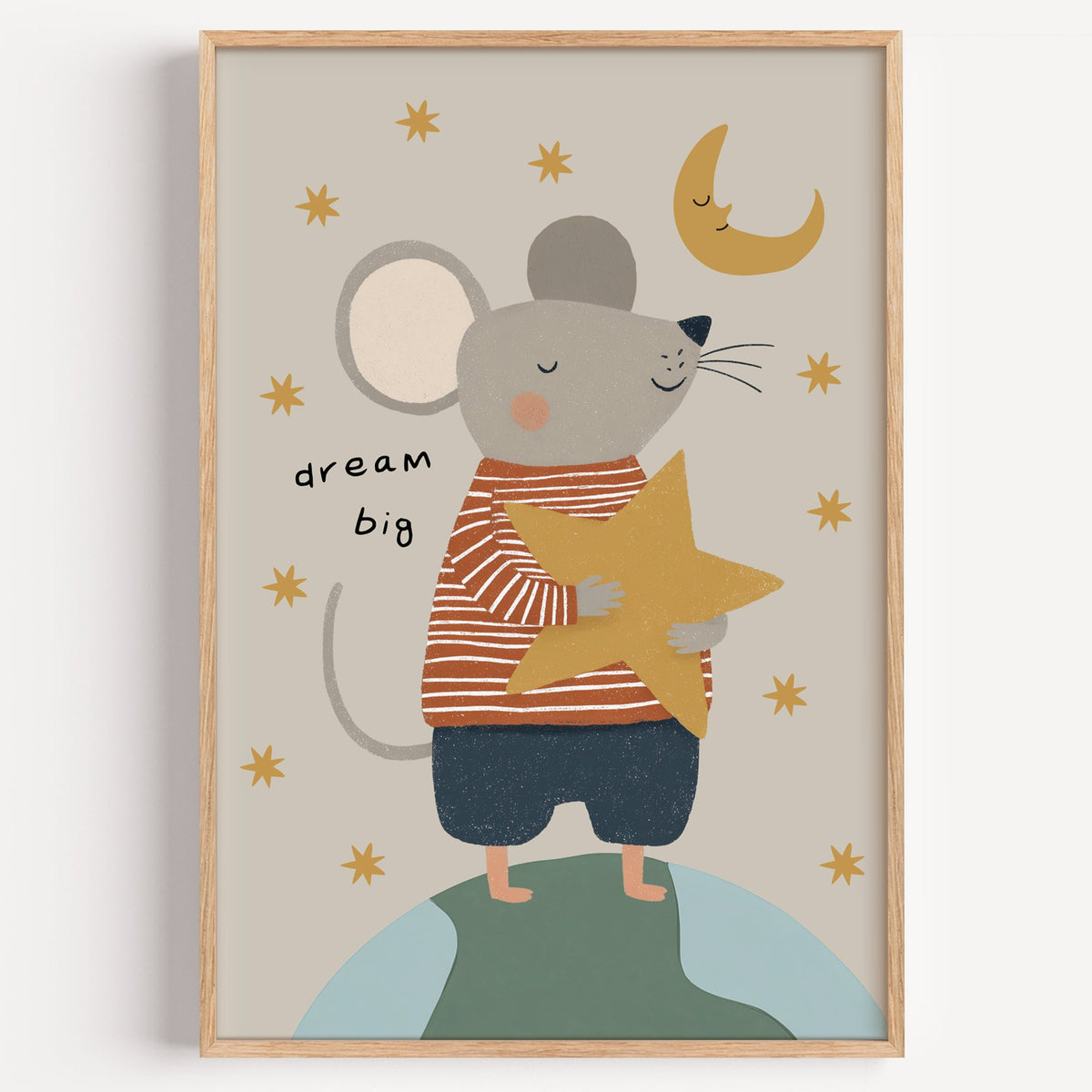 Dream big mouse hugging star nursery print in a light oak frame on a plain white wall