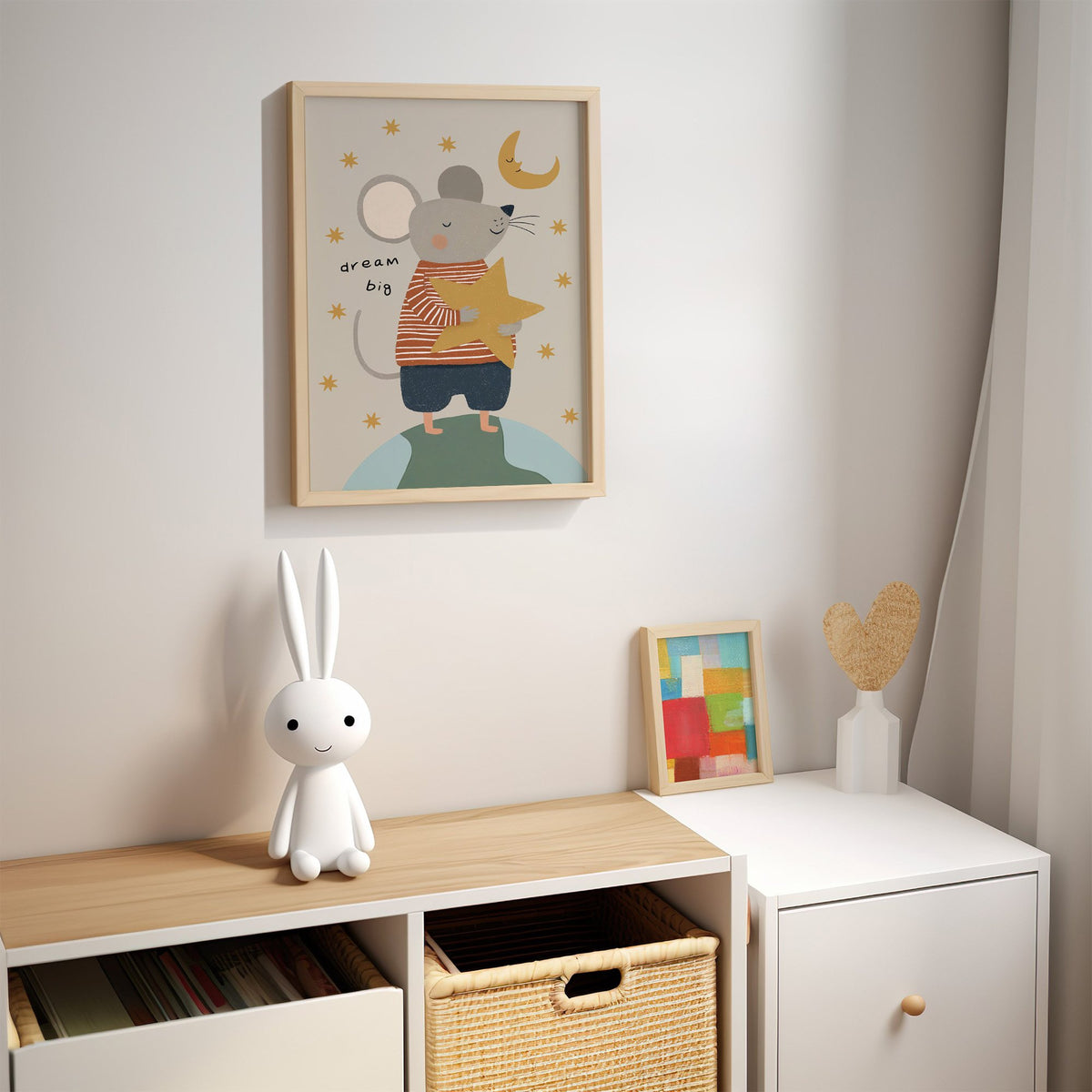Dream big mouse hugging star nursery print in an oak frame above a kids cubby shelf with a woven basket and bunny lamp