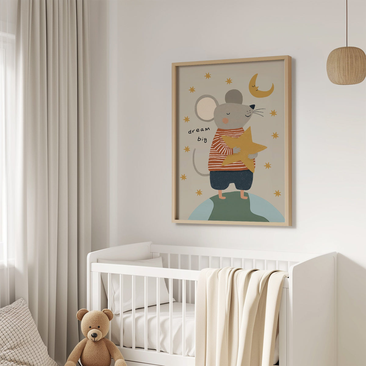 Dream big mouse hugging star nursery print in an oak frame above a white crib with a teddy bear