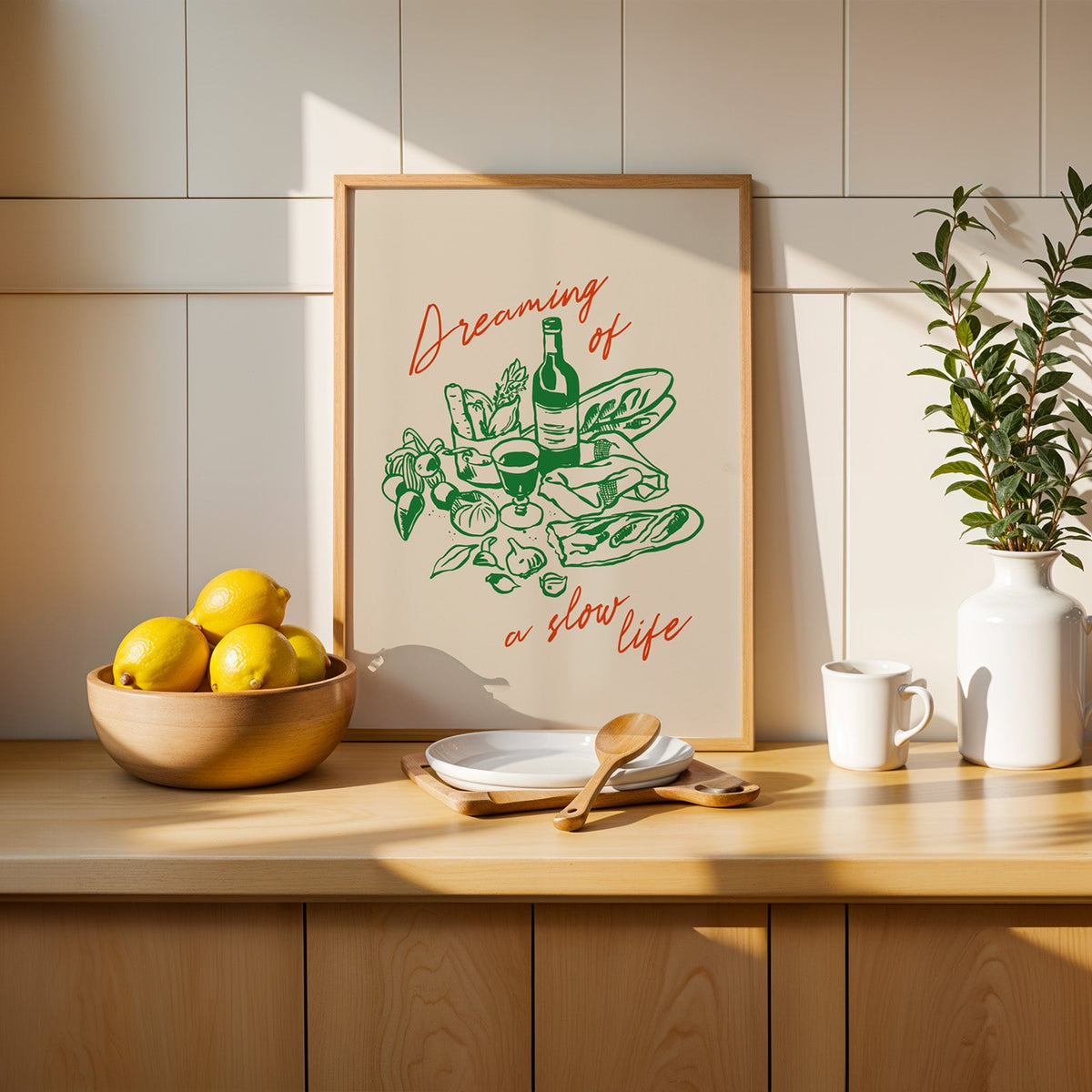 Dreaming of a Slow Life print in a slim oak frame beside a wooden bowl of lemons