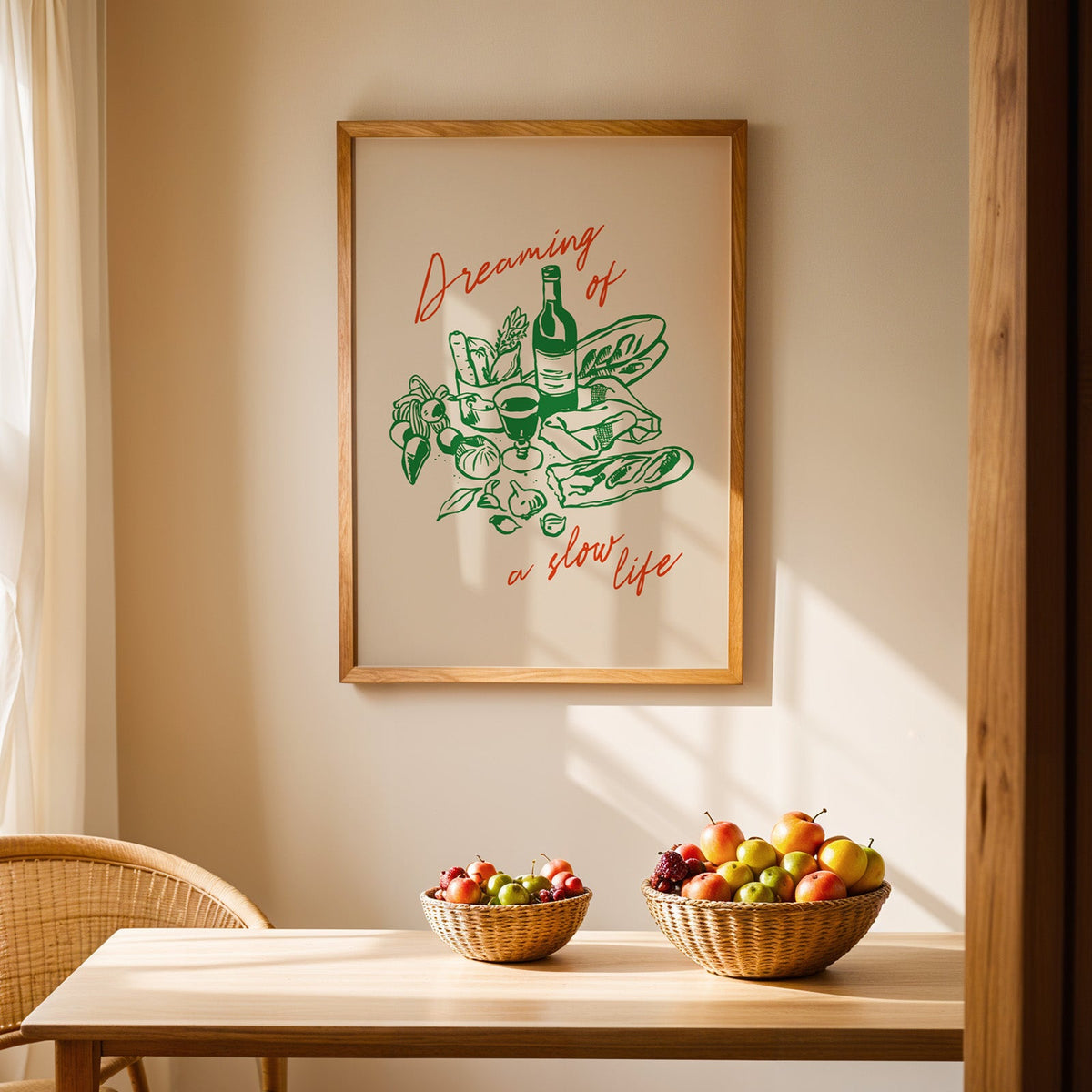 Dreaming of a Slow Life print in an oak frame above a dining table with rattan chairs