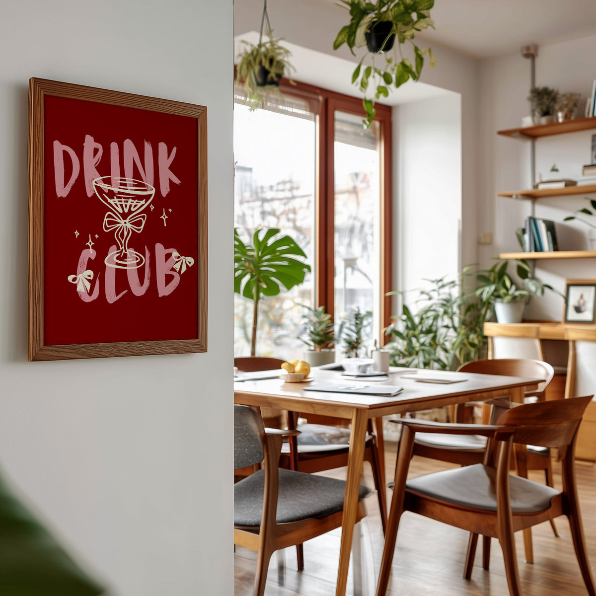 Drink Club print in a walnut frame beside a mid-century dining table