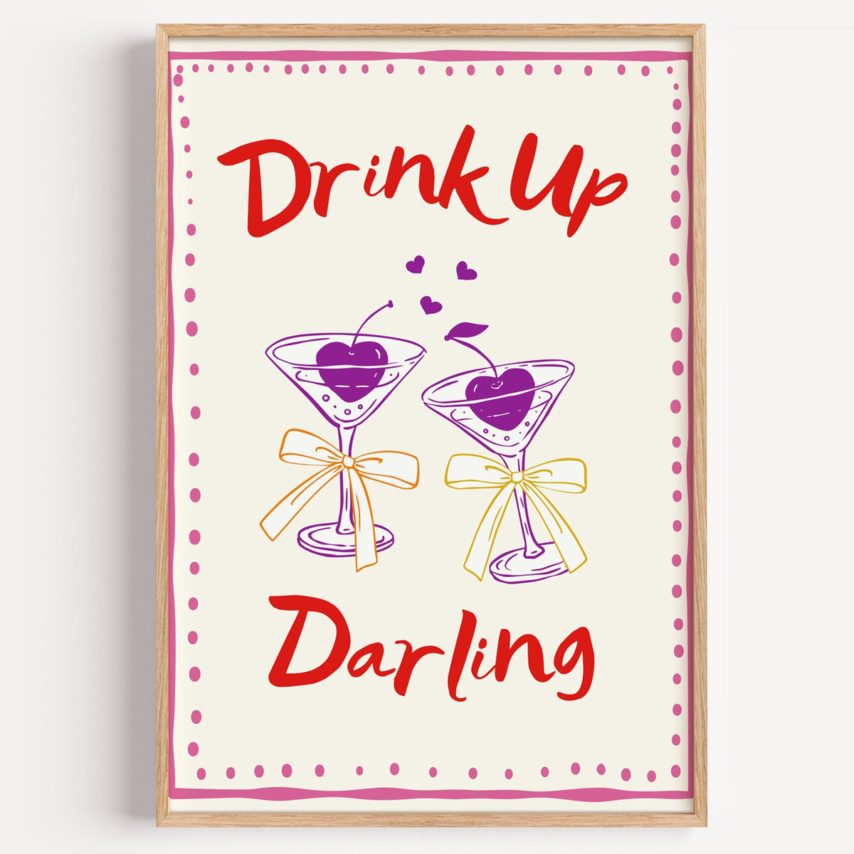 Drink Up Darling martini print in a light oak frame on a plain white wall