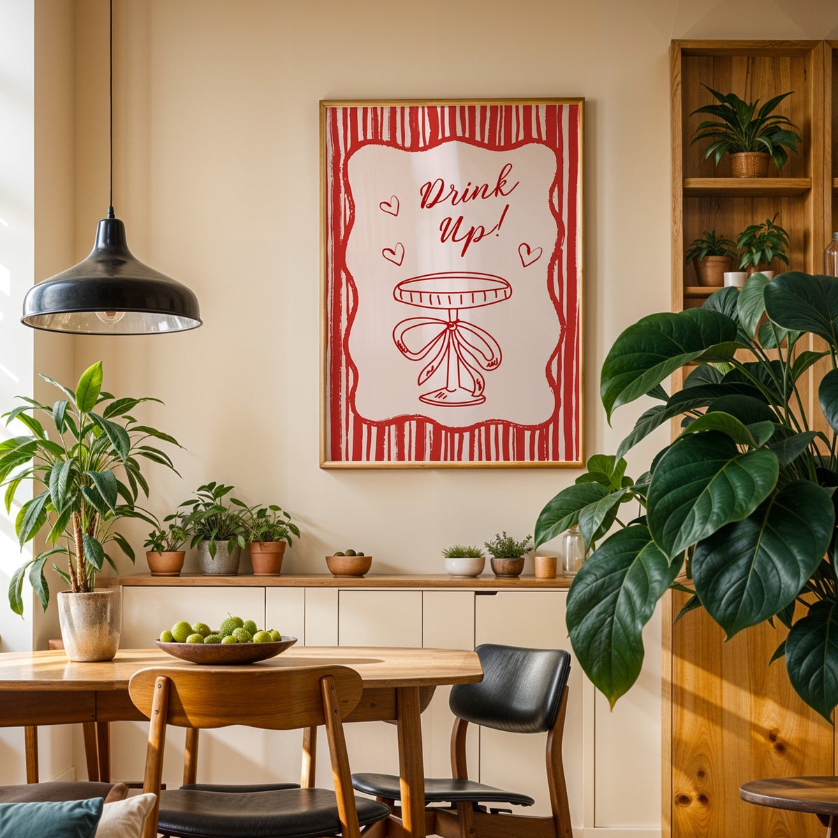 Drink Up coupe print in an oak frame in a dining room above a plant-lined sideboard