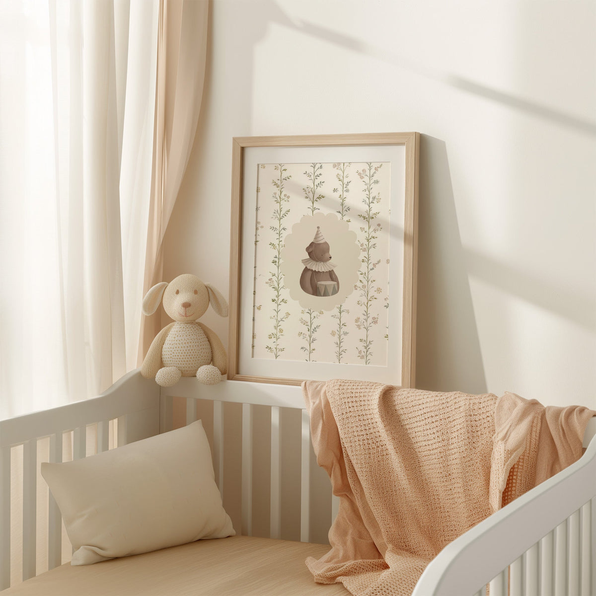 Teddy bear with a toy drum in a scalloped oval nursery print shown in an oak frame with a white mat on a crib rail