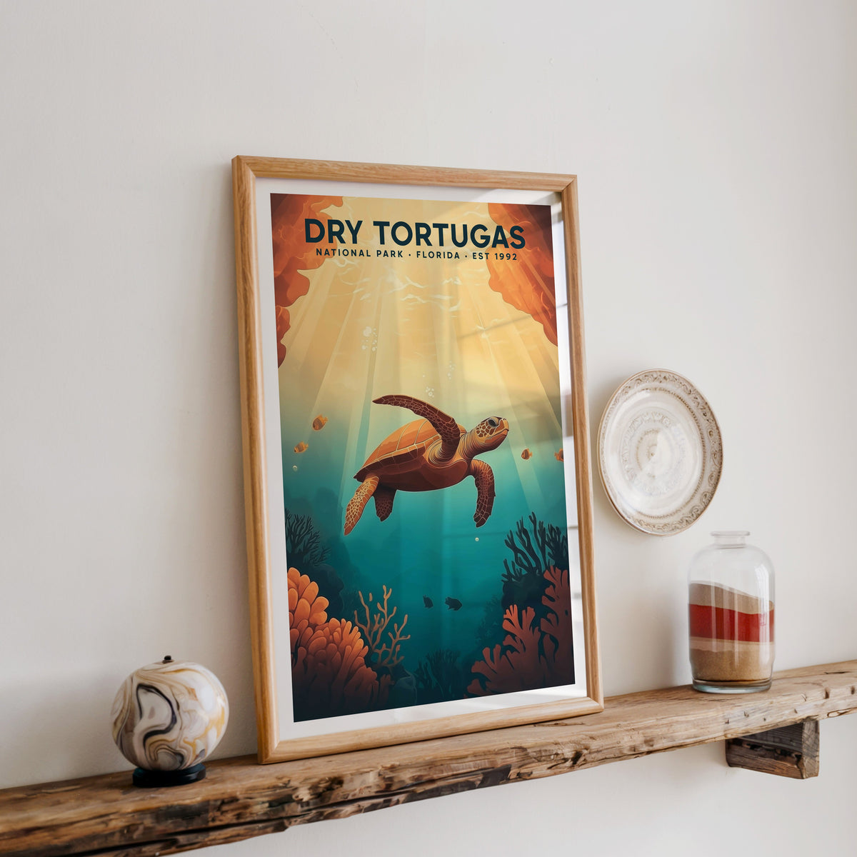 Dry Tortugas National Park print in an oak frame on a rustic wood shelf with ceramics